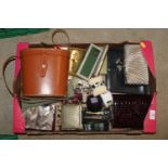 A box containing various purses, binocular case, e