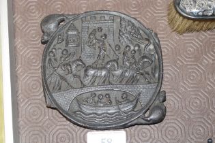 An antique carved plaque depicting castle and figures