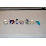 Seven glass paperweights to include Caithness and