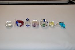 Seven glass paperweights to include Caithness and