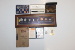 A framed and glazed display of coins; a 1982 Falkl