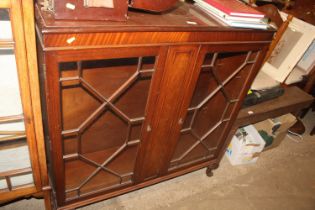 A mahogany glazed bookcase enclosed by astragal gl