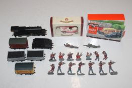 A box containing lead soldiers, die-cast vehicles;