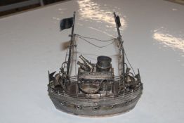 A white metal model of a boat, approx. 11oz (425gm