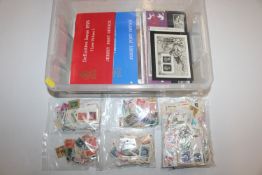 A box containing stamp album, various loose stamps