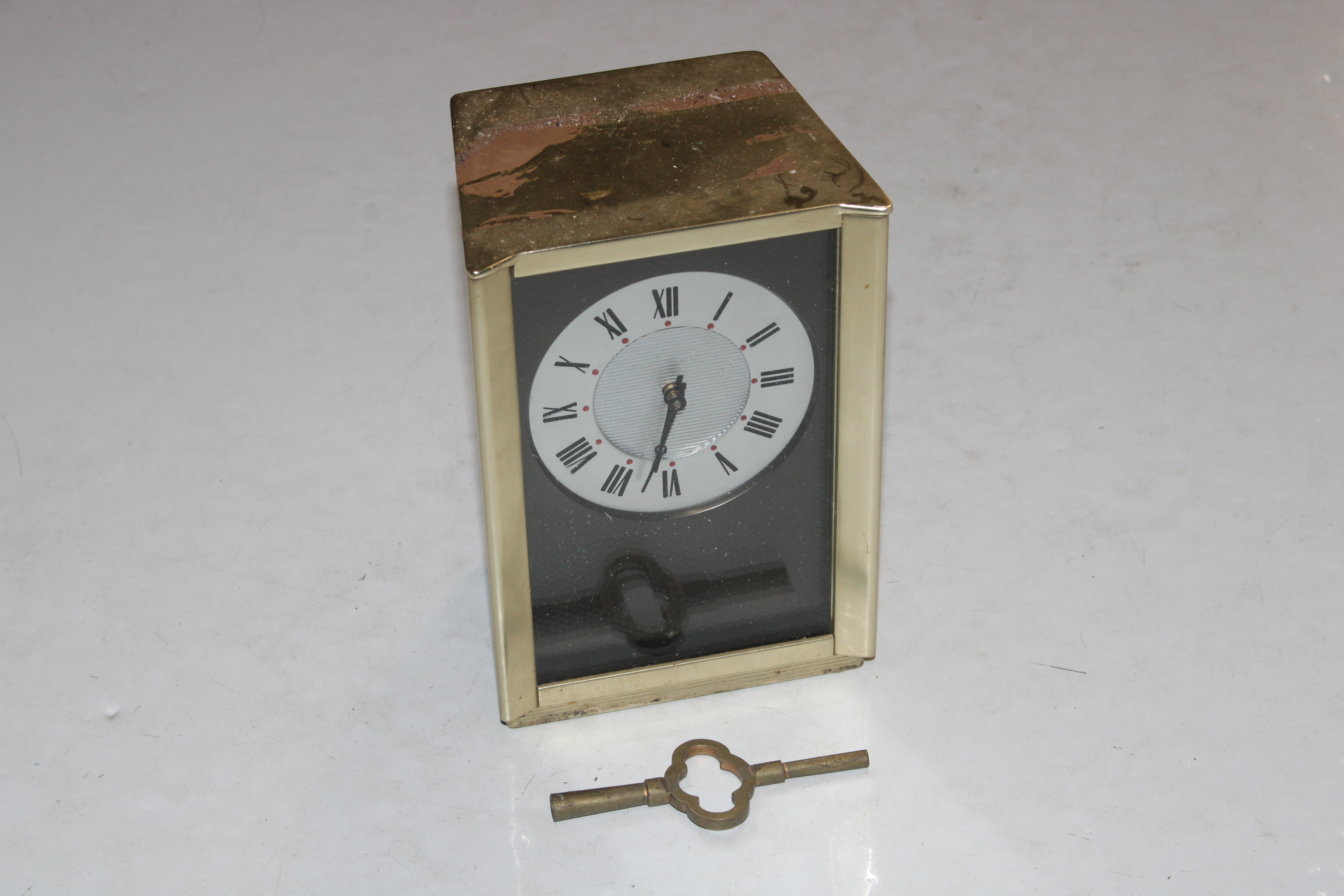 An Alcan mantel clock with plaque to the reverse d
