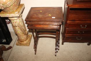 A nest of three mahogany occasional tables