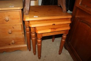 A nest of three modern pine coffee tables