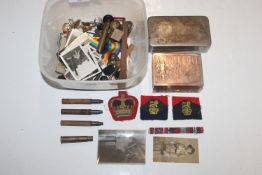 A box of mixed badges and other items