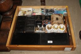 A wooden tray containing various artists materials