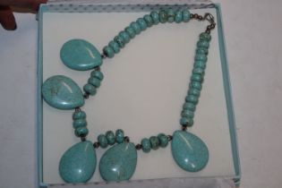 A boxed turquoise style necklace