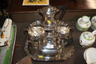 A plated four piece tea set and matching tray