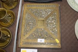 An antique brass blotter cover