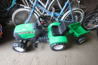 A child's pedal tractor and trailer
