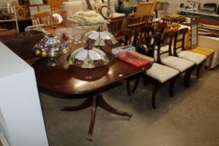 A reproduction mahogany drop leaf dining table and