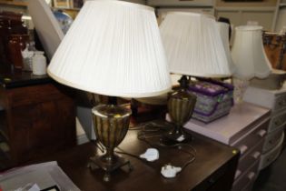 A pair of decorative metal table lamps and shades