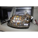 A stained glass table lamp in the form of a cat