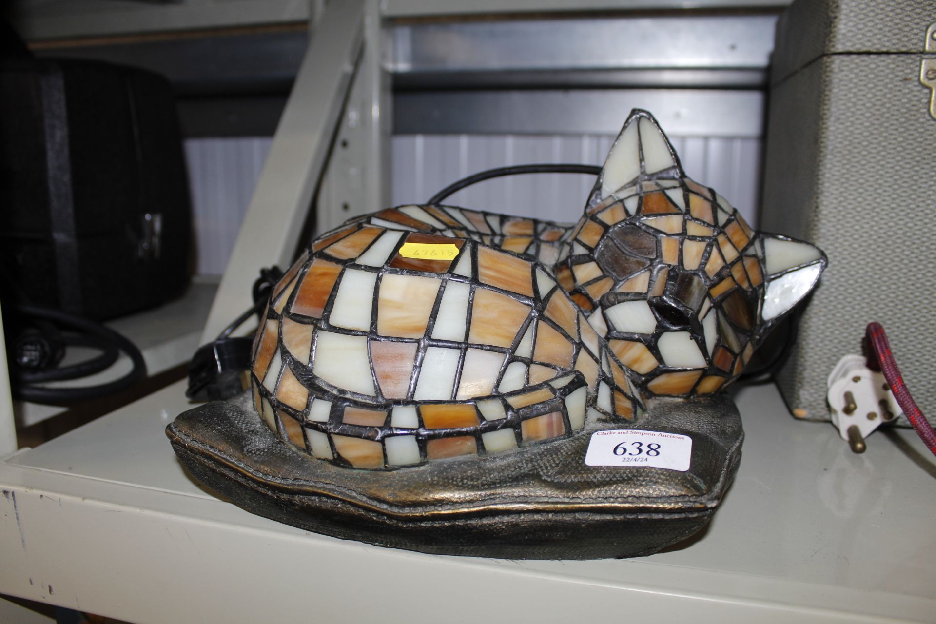 A stained glass table lamp in the form of a cat