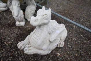 A cast concrete garden statue in the form of a rec