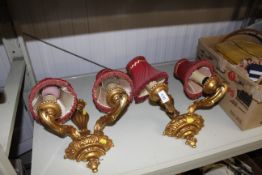 A pair of ornate gilt twin branch wall lights