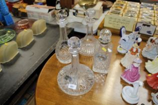 A cut glass ships decanter and three other decante