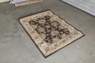 An approx. 5'4" x 4" brown patterned rug