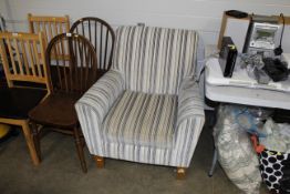 A striped upholstered arm chair