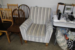 A striped upholstered arm chair