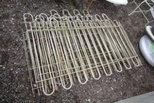 Seven sections of metal fence railing