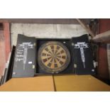 A Winmau dart board containing in a wooden two doo