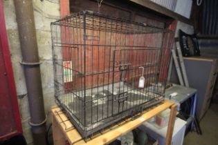 A metal folding pet cage