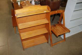 A set of oak bookshelves and a pine folding chair