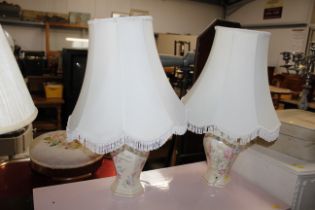 A pair of floral decorated table lamps and shades