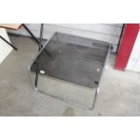 A metal framed glass top coffee table