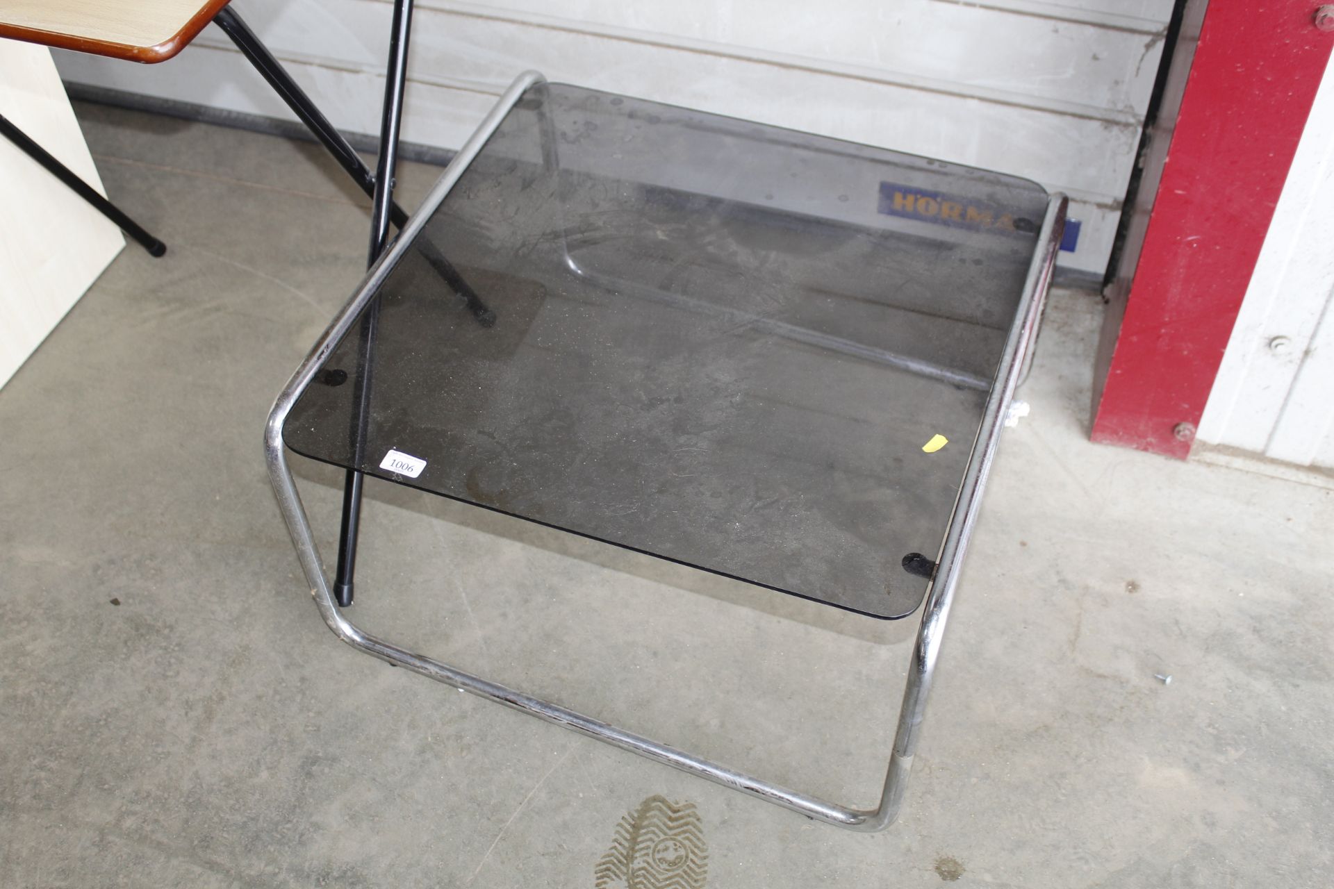 A metal framed glass top coffee table
