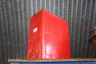 A metal red painted 2 gallon fuel can with brass c