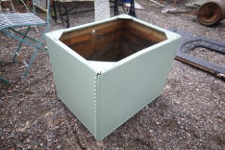 A green painted galvanised water tank/planter