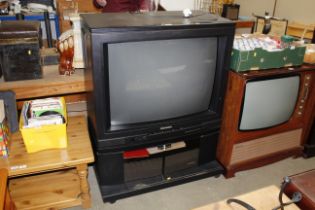 A Mitsubishi television and stand