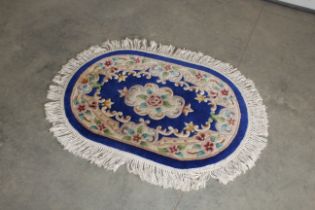 An approx. 4'5" x 3'2" oval patterned rug