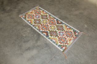 An approx. 4'7" x 2" Chobi Kilim rug