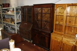 A reproduction mahogany bookcase on cupboard base