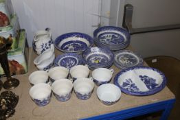 A collection of blue and white Willow patterned di