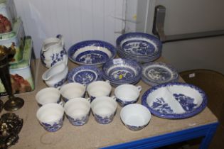 A collection of blue and white Willow patterned di