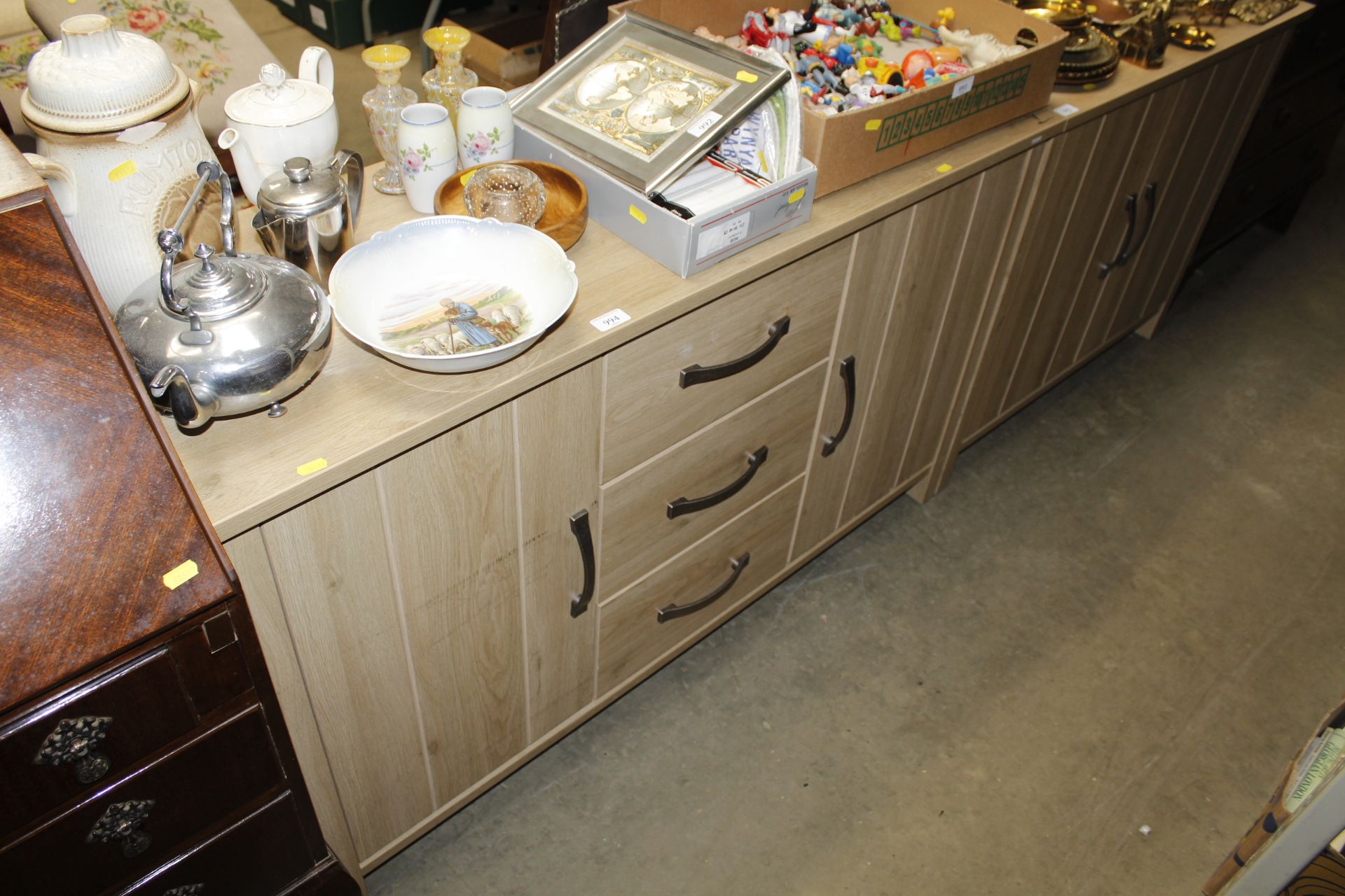 A lightwood effect sideboard fitted three central