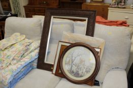 A carved oak picture frame and collection of prints