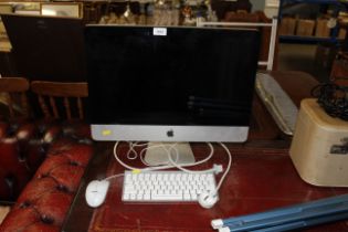 An Apple iMac computer with keyboard and mouse