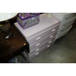 A pink painted chest fitted four drawers