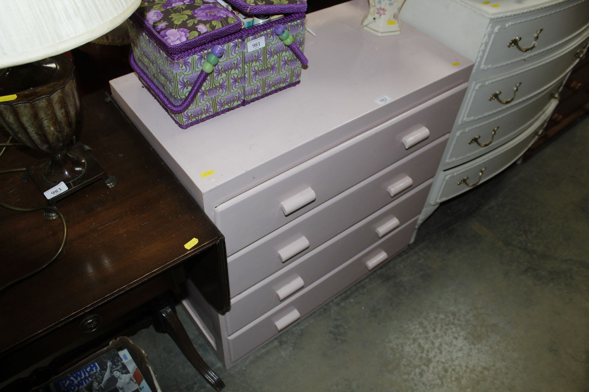 A pink painted chest fitted four drawers