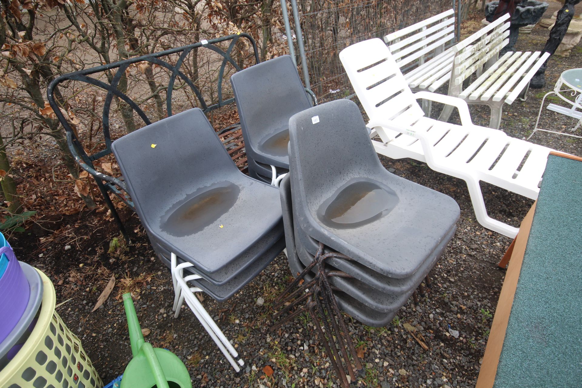 A quantity of plastic stacking chairs