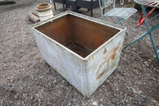 A large galvanised riveted water tank/planter